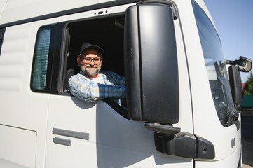 Naklejka premium Professional Semi Truck Driver Behind the Wheel of a Classic Truck