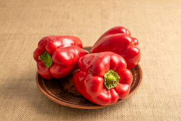 Sweet red bell pepper on jute cloth, macro.
