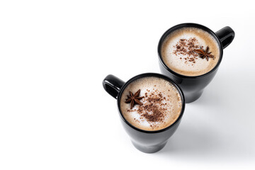Chai Latte in Black Mug with cinnamon and star anise isolated on white background. Copy space