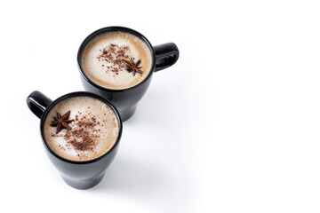 Chai Latte in Black Mug with cinnamon and star anise isolated on white background. Copy space