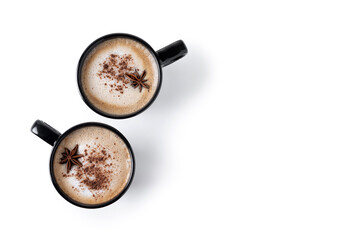 Chai Latte in Black Mug with cinnamon and star anise isolated on white background. Copy space