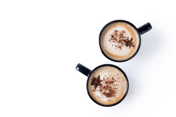 Chai Latte in Black Mug with cinnamon and star anise isolated on white background. Copy space