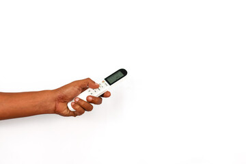 Close up hand hold and press button of white Air conditioner remote control isolated on white...