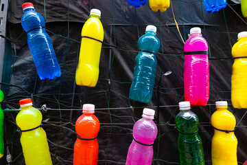 Plastic bottles filled with colored liquid