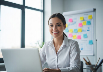 Businesswoman working on a laptop in the office smiling and happy about business strategy and financial data analysis for future growth