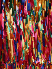 long stripes of colorful textile hanging in a street for summer decoration closing the sky