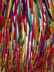 long stripes of colorful textile hanging in a street for summer decoration in a slight bend by the...