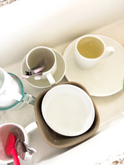 Clean Dish Rack with Cups and Bowls on White Shelf