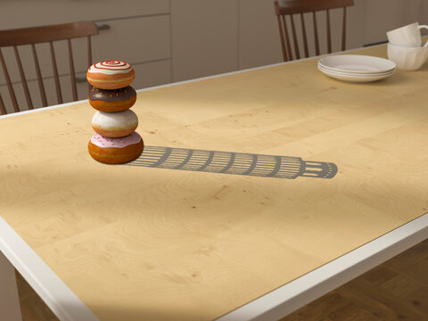 Creative donut stack resembling Tower of Pisa with shadow on table