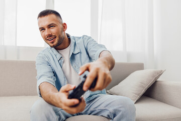 Engaged man playing video games at home, showing the balance between relaxation and technology use....