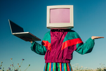 AI concept person in vintage track suit with CRT monitor head and laptop