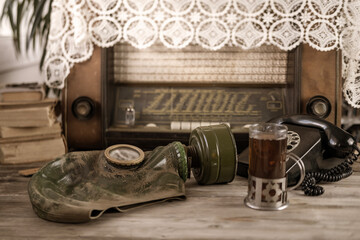 Vintage gas mask and old-fashioned rotary dial phone, relics of the past, evoking sense history and...