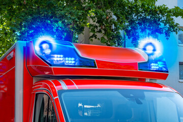 Closeup Flashing blue emergency lights on German fire rescue van, Emergency ambulance parked on...