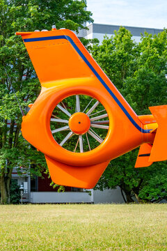 orange helicopter's tail, featuring its advanced Fenestron rotor system, Emergency rescue helicopter, German transport medical Luftrettung ready for emergency mission, Aviation technology