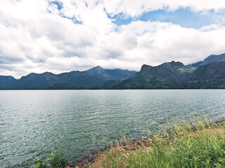 Mountain scenery view with river and cloudy skies