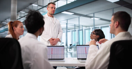 Multiracial Medical Team Collaborates Using Laptops