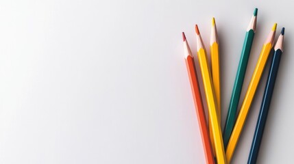 Fototapeta premium Group of Colored Pencils with Orange Yellow and Blue on White Surface Featuring Clean and Bright Lighting Style Perfect for School Supplies Design