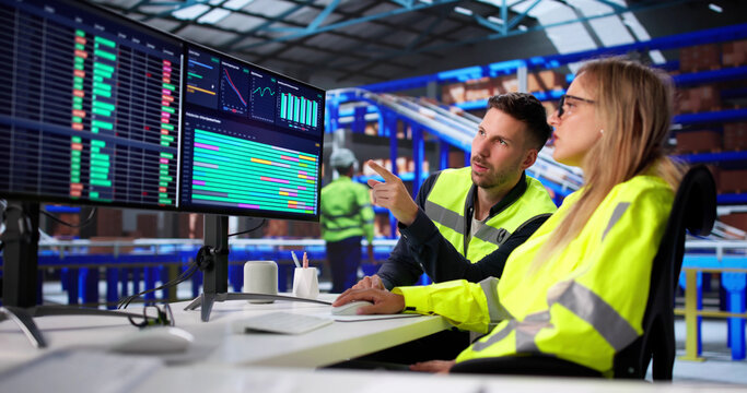 Warehouse Manager Analyzes Spreadsheets On Desktop Computer