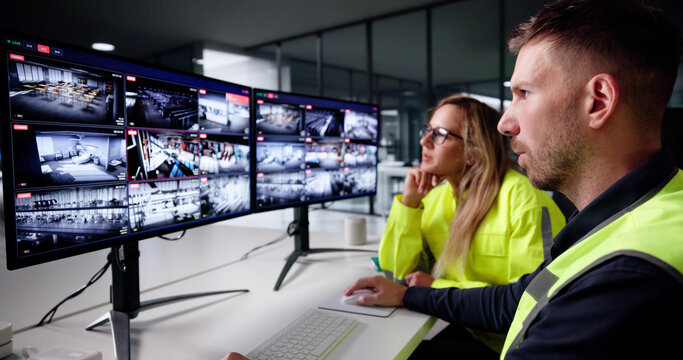 Corporate Surveillance Operator Examines CCTV Security Camera Control System