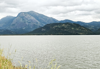 Mountain scenery view with river and cloudy skies