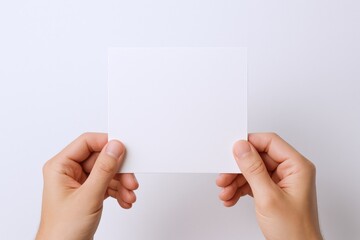 Hands Holding a Blank Square Card, Perfect for Mockups, Invitations, or Personalized Messages on White Background