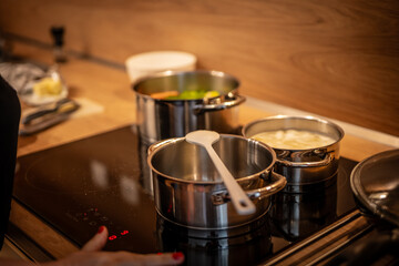 Hands, cooking and pot with steam in the home for lunch or dinner, busy and hungry for food with preparation. Catering, meal with nutrition in kitchen.