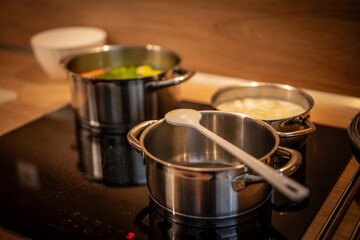 Hands, cooking and pot with steam in the home for lunch or dinner, busy and hungry for food with...