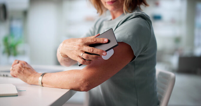 Elderly Woman Monitors Glucose Levels Remotely