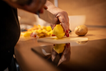 Close up photo of female hands is preparing wonderful fresh potato food. Chef cooking food cutting prepare hands knife preparing potato.