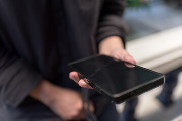 Hand Holding Smartphone with Blank Screen Mockup for Technology and App Design