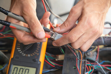 Caucasian electric repairing motorcycle electrical system.