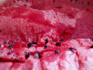 An incredible macro shot showcases the rich texture and deep red color of juicy watermelon pulp....
