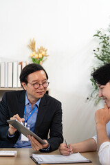 Insurance Consultation. Businessman explaining policy details with client in office.