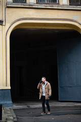Charming urban architecture meets a solitary figure savoring coffee while exploring a historic...