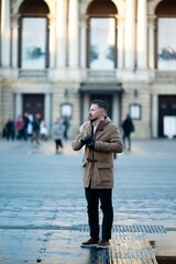 Chilly afternoon stroll in a bustling urban square evokes a sense of reflection and connection...