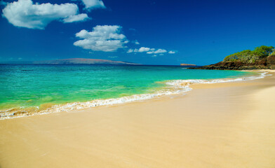 Pristine tropical beach with clear turquoise water and blue sky. Makena, Makena state park, Oneloa beach, Maui, Hawaii