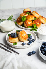 syrniki . Appetizing cheesecakes with sauce and blueberries