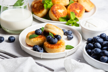 syrniki . Appetizing cheesecakes with sauce and blueberries