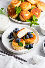 syrniki . Appetizing cheesecakes with sauce and blueberries
