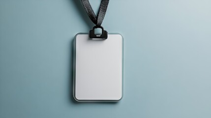 Fototapeta premium Close-up of ID card holder with blank card and attached lanyard, isolated on neutral background, ideal for business, office, or conference mockups