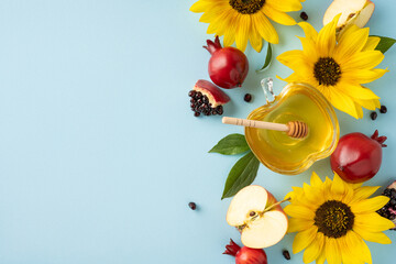 Colorful composition of honey, pomegranates, sunflowers, apples, and leaves symbolizing Rosh...