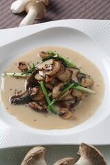 Close-up of stir-fried mushrooms served with creamy sauce, a flavorful Korean fusion dish prepared by master chef Hanshunseop. Photographed in Korea.