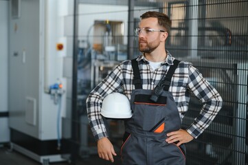 Factory worker. Man with helmet working with pvc