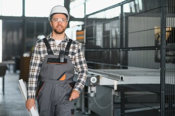 Factory worker. Man with helmet working with pvc