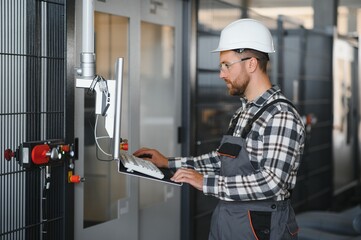 Technician operating machine in a factory