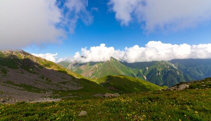Expansive mountain vista showcasing rolling hills, lush greenery, and dramatic cloudscapes against a brilliant blue sky.