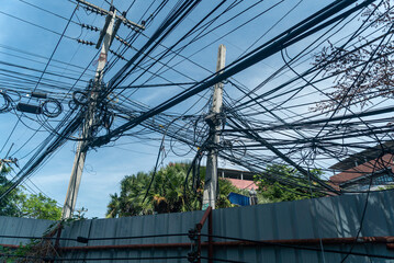Chaotic Urban Power Lines Against Sky