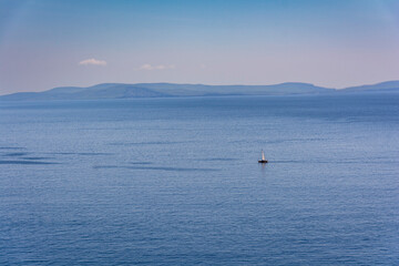 Wild atlantic way, Dingle peninsula ocean view - motor boat in the blue calm sea