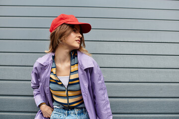 Young beautiful woman enjoying a summer vibe against a stylish gray wall backdrop