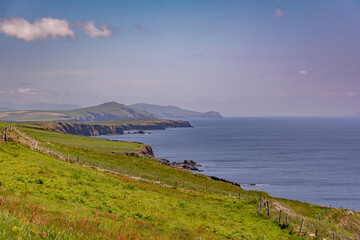 view from the top of the mountain towards atlantic ocean shore at dingle peninsula
